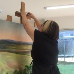 Artist adjusting easel in her art studio