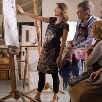 Six Ways to Fill Your Art Classes and Workshops With More Students 4 Art Class woman artist tutor giving feedback to students